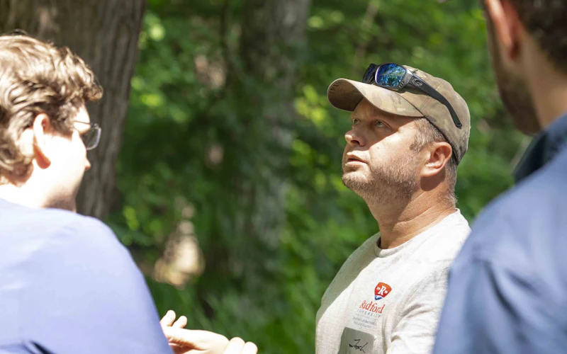 Field consultants talking through a site visit outdoors
